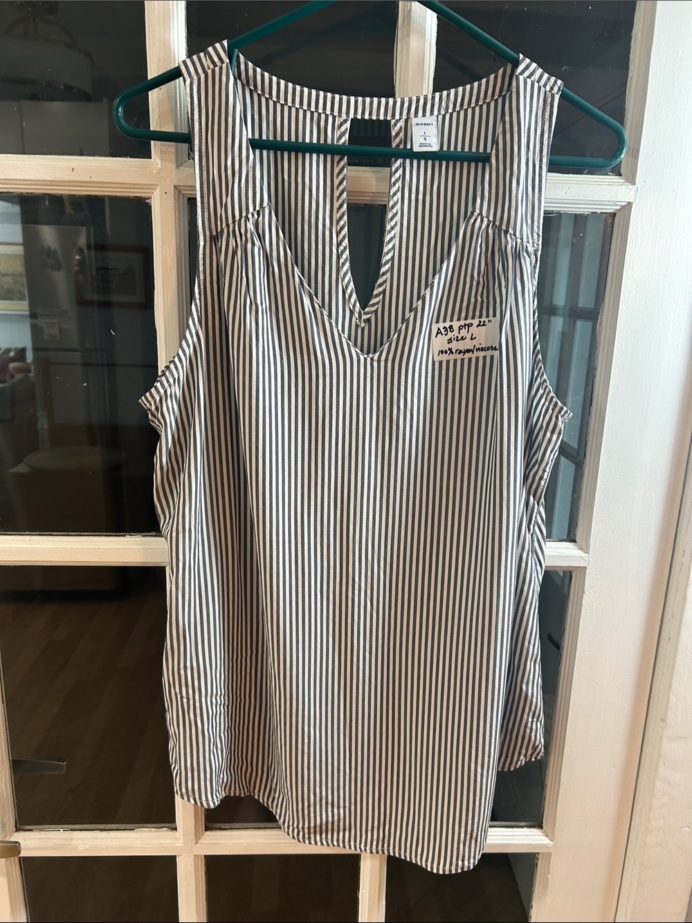 A38.    Old Navy Black and White Striped Sleeveless Button Down Shirt